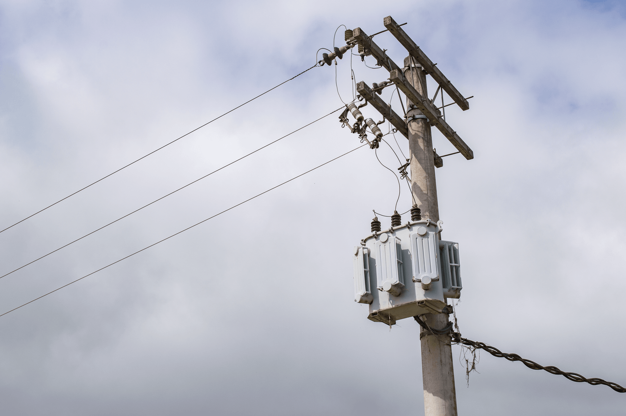 Low-angle shot of a power line on an electric post against a cloudy sky in São Paulo, Brazil.
